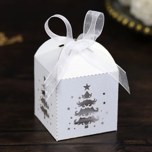 Detailed laser-cut Christmas tree paper candy box with elegant white organza ribbon bow