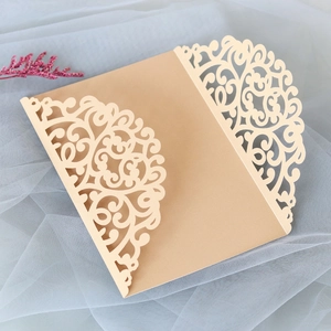 Detail of laser-cut floral pattern on champagne gold invitation card cover
