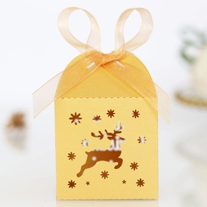 Detail of golden reindeer hollow laser-cut candy box with a soft ribbon bow