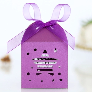 Detail of purple star-shaped paper gift box with镂空 star pattern and satin ribbon bow