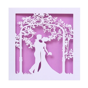Elegant laser cut white wedding invitation card with romantic couple and floral arch design