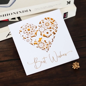 Detailed laser-cut heart and butterfly design on a golden Best Wishes greeting card