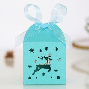 Macro view of light blue Christmas candy box with laser-cut reindeer and snowflake patterns