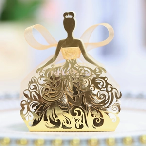 Macro shot of gold princess dress candy box with laser-cut lace and silk bow