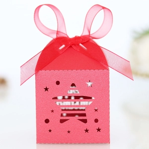 Detail of red hollow star gift box with sheer organza ribbon and Merry Christmas text