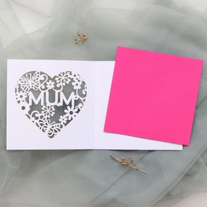 Macro detail of laser-cut MUM floral heart pattern on Thanksgiving greeting card