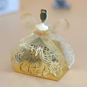 Macro view of laser-cut princess silhouette gold candy box with silk ribbon detail