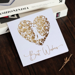 Laser-cut white wedding card with a golden heart silhouette and Best Wishes text