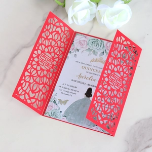 Laser-cut red double happiness wedding card with rose print insert on marble surface