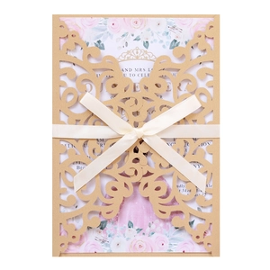 Elegant gold laser cut wedding invitation with cream ribbon bow and floral card insert