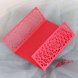 Close-up of laser-cut double happiness wedding card with intricate floral patterns
