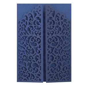 Detail of navy blue laser-cut wedding invitation featuring intricate floral patterns