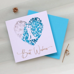 Detail of laser-cut heart card with couple silhouette and blue envelope for best wishes