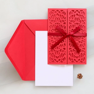 Laser-cut red wedding invitation with traditional double happiness logo and silk ribbon