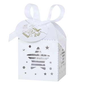 Macro view of white star-shaped hollow gift box with satin ribbon and Thank You card