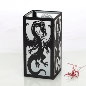 Detail showing a black dragon silhouette paper lantern with intricate cutout patterns