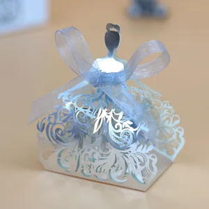 Detail of silver laser-cut princess dress candy box with blue ribbon and floral hollow patterns