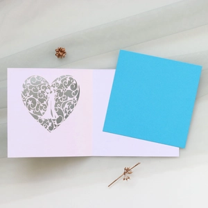 Laser cut pink wedding greeting card with heart couple silhouette and light blue insert