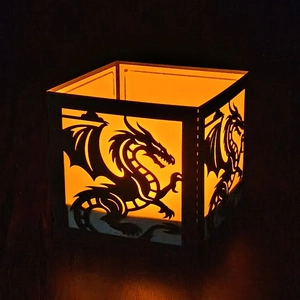 Square black dinosaur paper lantern with warm orange light for festive atmosphere