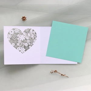 Detail view of laser-cut heart floral butterfly card with Tiffany blue inner sheet