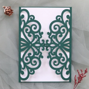 Detailed laser cut vine pattern on dark green wedding invitation with elegant cardstock