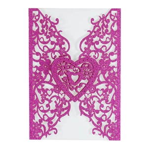 Glittery magenta laser cut wedding invitation cover with elegant hollow heart and floral pattern