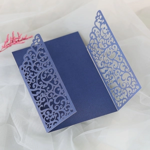 Detailed laser-cut vine patterns on a dark blue pearlescent trifold invitation card