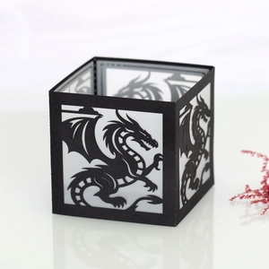 Detailed laser-cut dragon pattern on square black paper lantern with inner white layer
