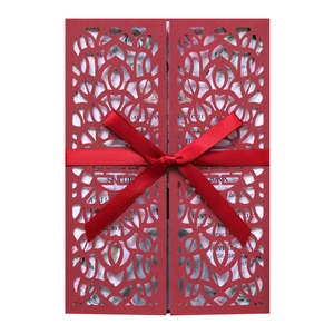 Laser-cut red wedding invitation card with elegant satin ribbon and floral insert