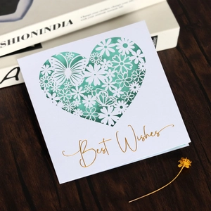 Detail of laser-cut heart pattern card with gold foil Best Wishes on mint green paper