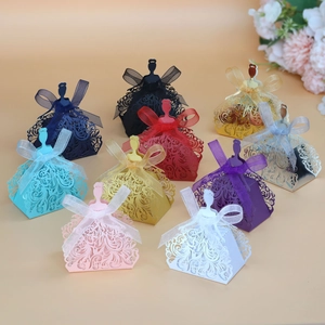 Detailed laser-cut princess dress candy boxes in various colors with organza ribbons