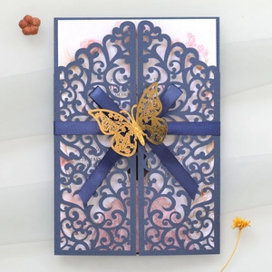 Detail of laser cut navy blue invitation with pink floral insert and golden butterfly