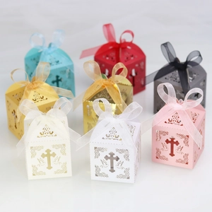 Detailed view of laser-cut gift boxes with ribbon bows and cross patterns in various colors
