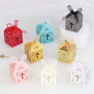 Detail of laser-cut cross gift boxes in various colors with matching silk ribbons
