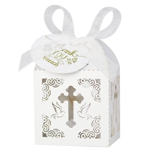Detail of white laser-cut cross gift box with white ribbon and Thank You gold tag
