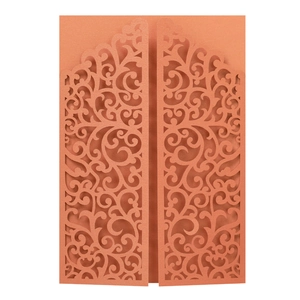 Macro detail of laser-cut pearl paper wedding invitation with intricate floral cutouts