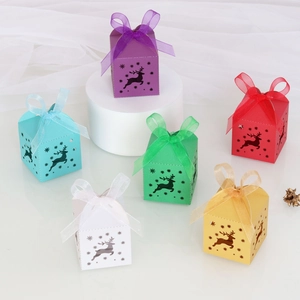 Detailed laser-cut reindeer and snowflake hollow patterns on festive candy gift boxes