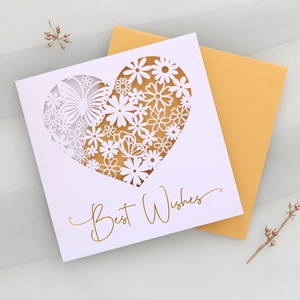 Detail of laser-cut white butterfly heart greeting card with gold foil Best Wishes text