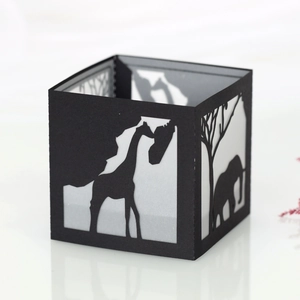 Detail of black paper lantern with African giraffe and elephant silhouette cutouts