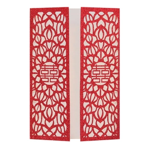 Detail of red laser-cut wedding invitation featuring the traditional Double Happiness symbol