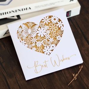 Detail of laser-cut heart pattern with butterflies and gold foil Best Wishes card
