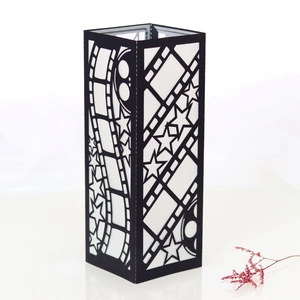 Detail of film theme black paper lantern featuring hollow carved movie film strip patterns