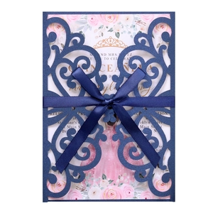 Detail of laser-cut navy invitation with pink rose card and elegant satin ribbon bow