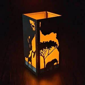 African savanna silhouette paper lantern with giraffe and elephant warm glowing cutouts