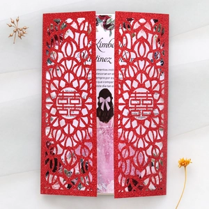 Detail of red glitter laser-cut wedding invitation with traditional Xi symbol and card