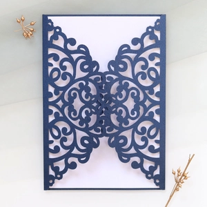 Detailed laser-cut navy blue wedding invitation cover with elegant European scroll patterns