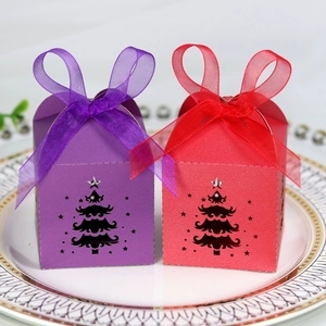 Detailed laser-cut Christmas tree candy boxes in red and purple with ribbon bows