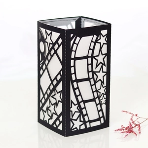 Macro shot of black movie theme paper lantern with film strip and star cutouts