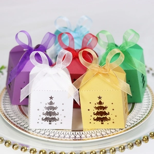 Laser-cut Christmas tree gift boxes in six colors with organza bows on a vintage tray