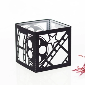 Macro view of film-themed black hollow paper lantern with film strip laser cutouts